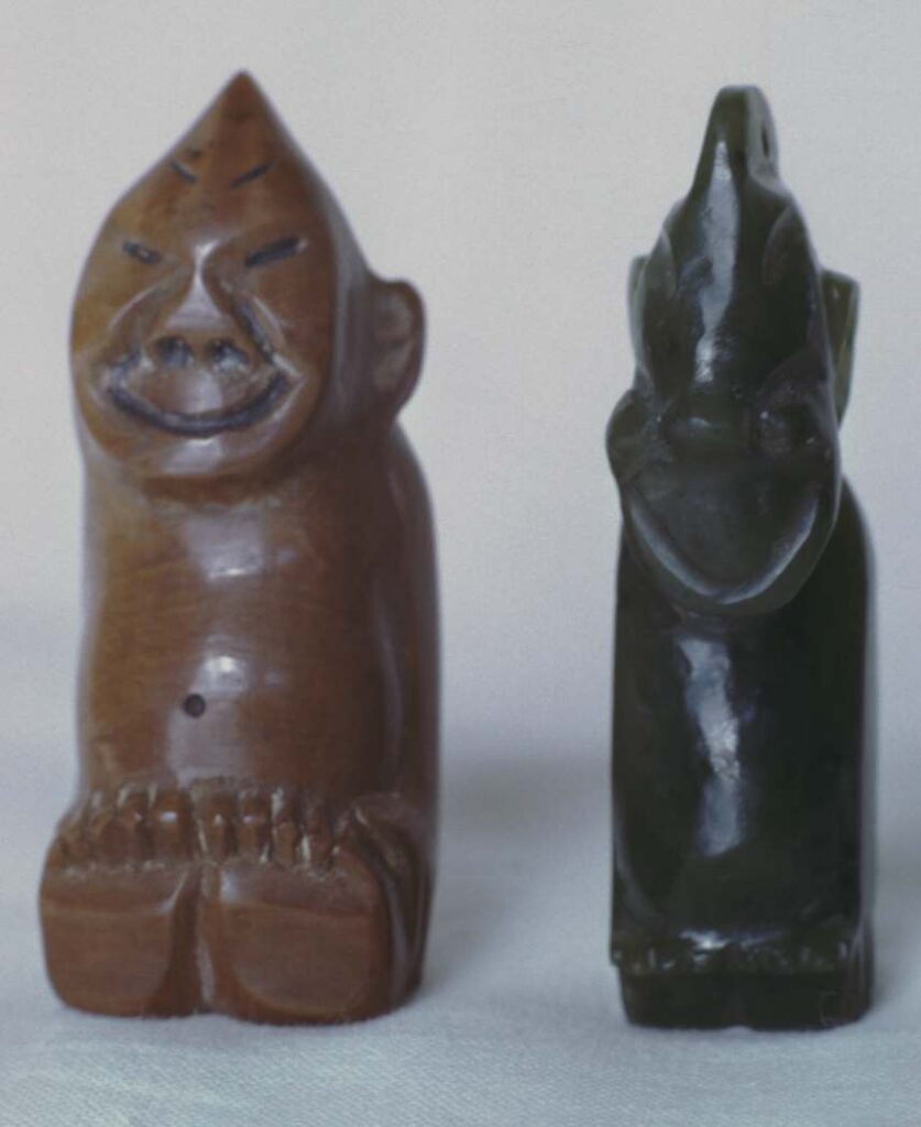 Left, figurine carved from mammoth ivory, two inches high, purchased in Wrangell about 1920. Right, pendant of nephrite, purchased in Whitehorse.